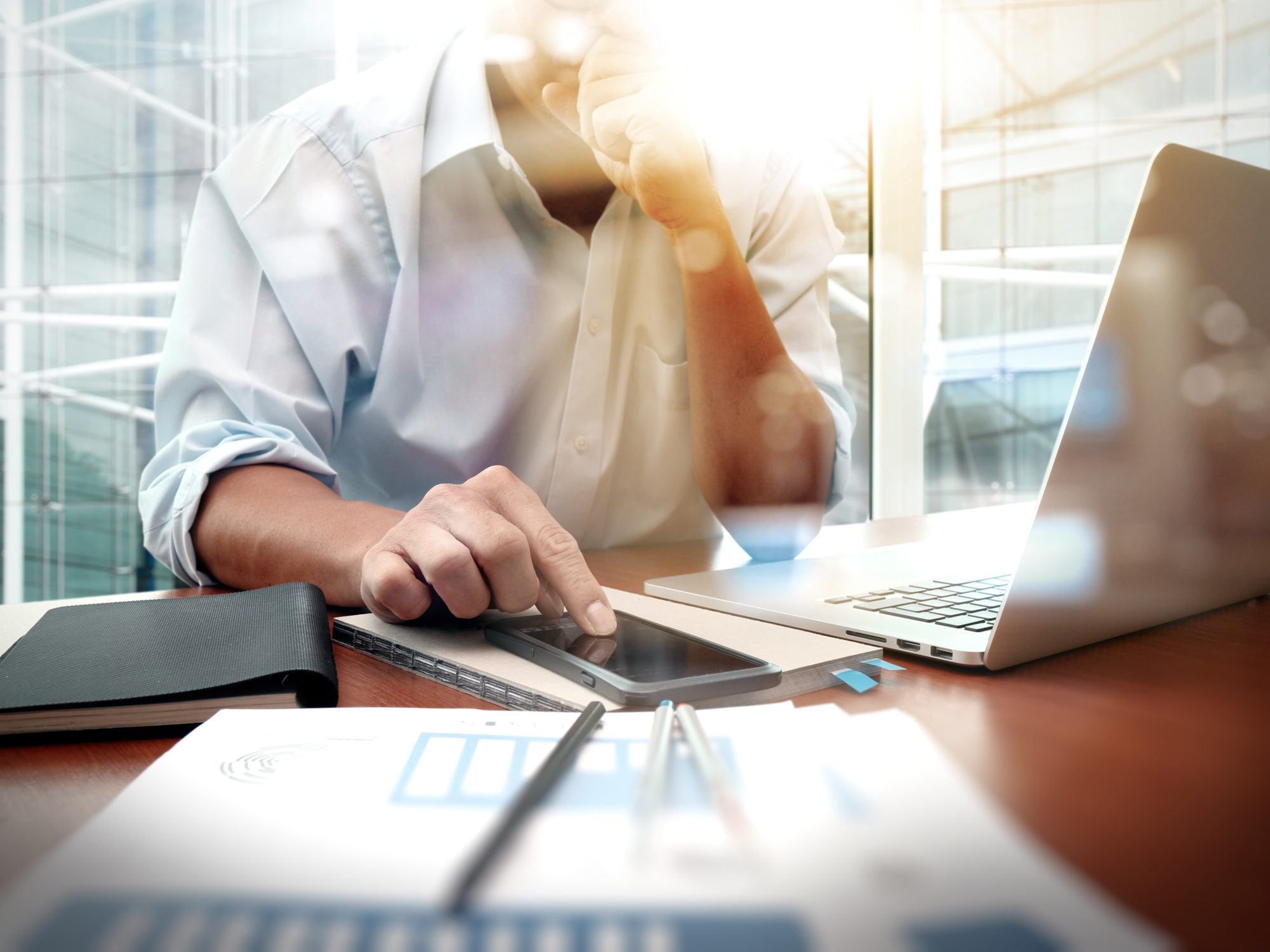 business documents on office table with smart phone and digital