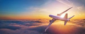 plane flying over the clouds during sunset