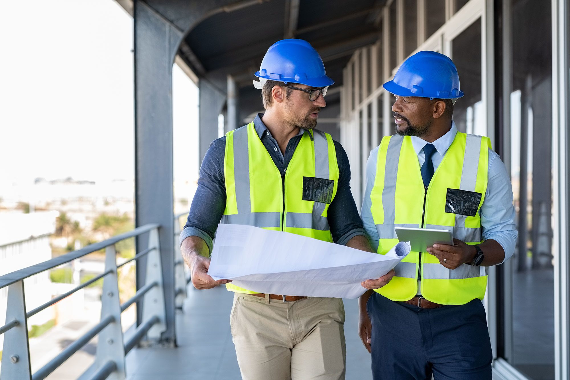 Metalworker and engineer meeting at construction site.