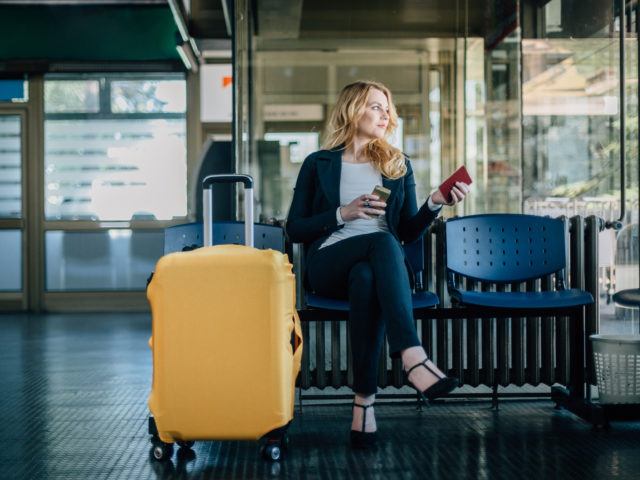 Businesswoman waiting for her flight at the airport