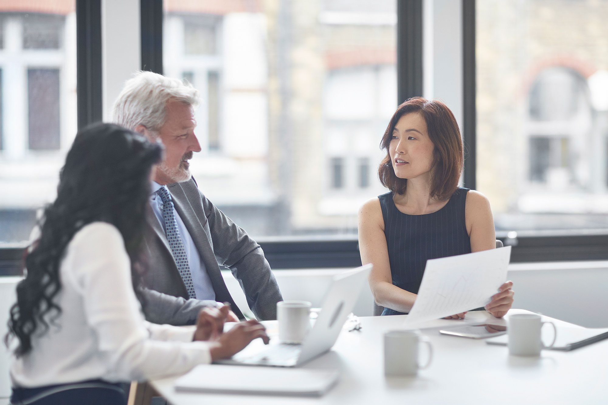 three business people in a meeting
